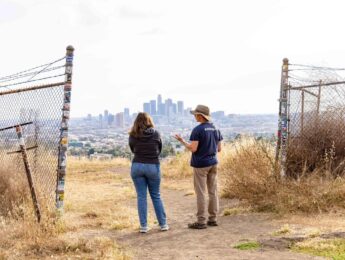 Demian Willette research with student in Ascot Hills Park overlooking DTLA