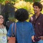 Miles Gibson outside talking to two women