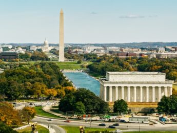Helicopter shot of the the National Mall in Washington, D.C. on a sunny day in Fall, looking over the Lincoln Memorial and past the Washington Monument Towards Capitol Hill.