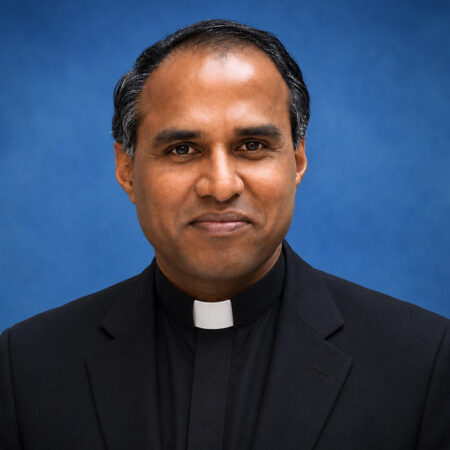 Headshot of Dominic S. Irudayaraj on a blue background