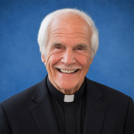 Headshot of Julio Giulietti on a blue background