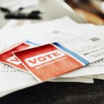 Voting ballot and other mail sitting on a stack on a kitchen counter of a home