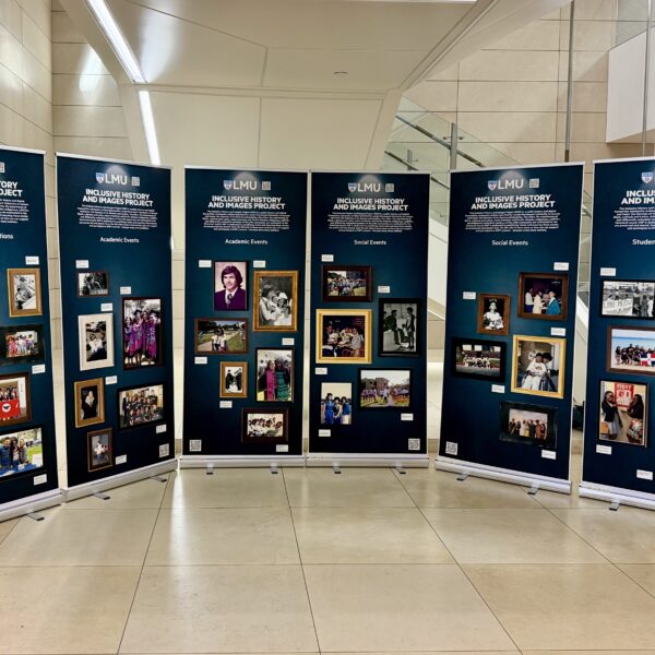 The Inclusive History and Images Project exhibition shows large posters with archival photos of academic and social events at LMU.