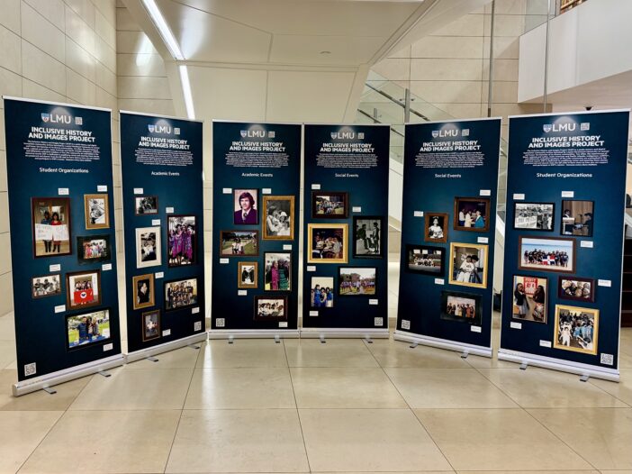 The Inclusive History and Images Project exhibition shows large posters with archival photos of academic and social events at LMU.