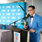 President Poon at podium of MEF signing ceremony