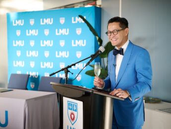 President Poon at podium of MEF signing ceremony