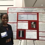 An LMU student with her research poster