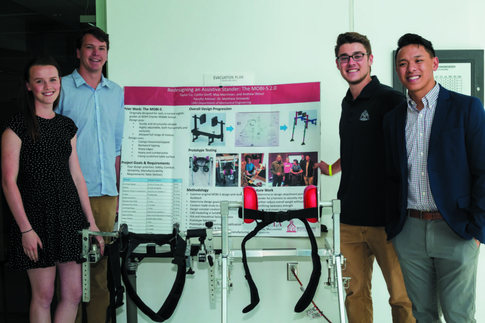 Seaver students, their research poster, and a prototype of their assistive stander