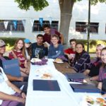 Seaver students sit at a table at the Seaver BBQ