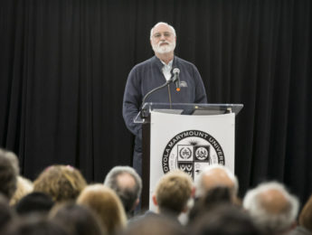 Father Gregory Boyle in front of a podium
