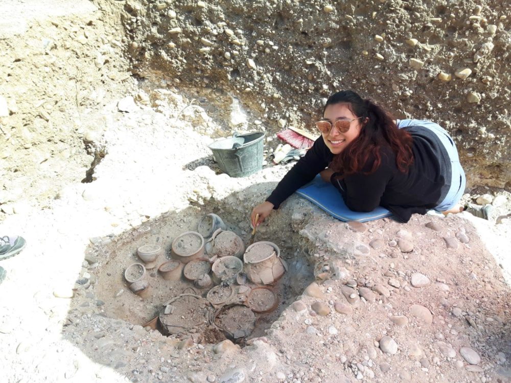 Rebecca Delacruz in front of a pile of ceramics in Spain