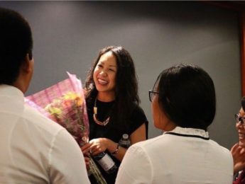 Chantel Nong, holding a bouquet of flowers.