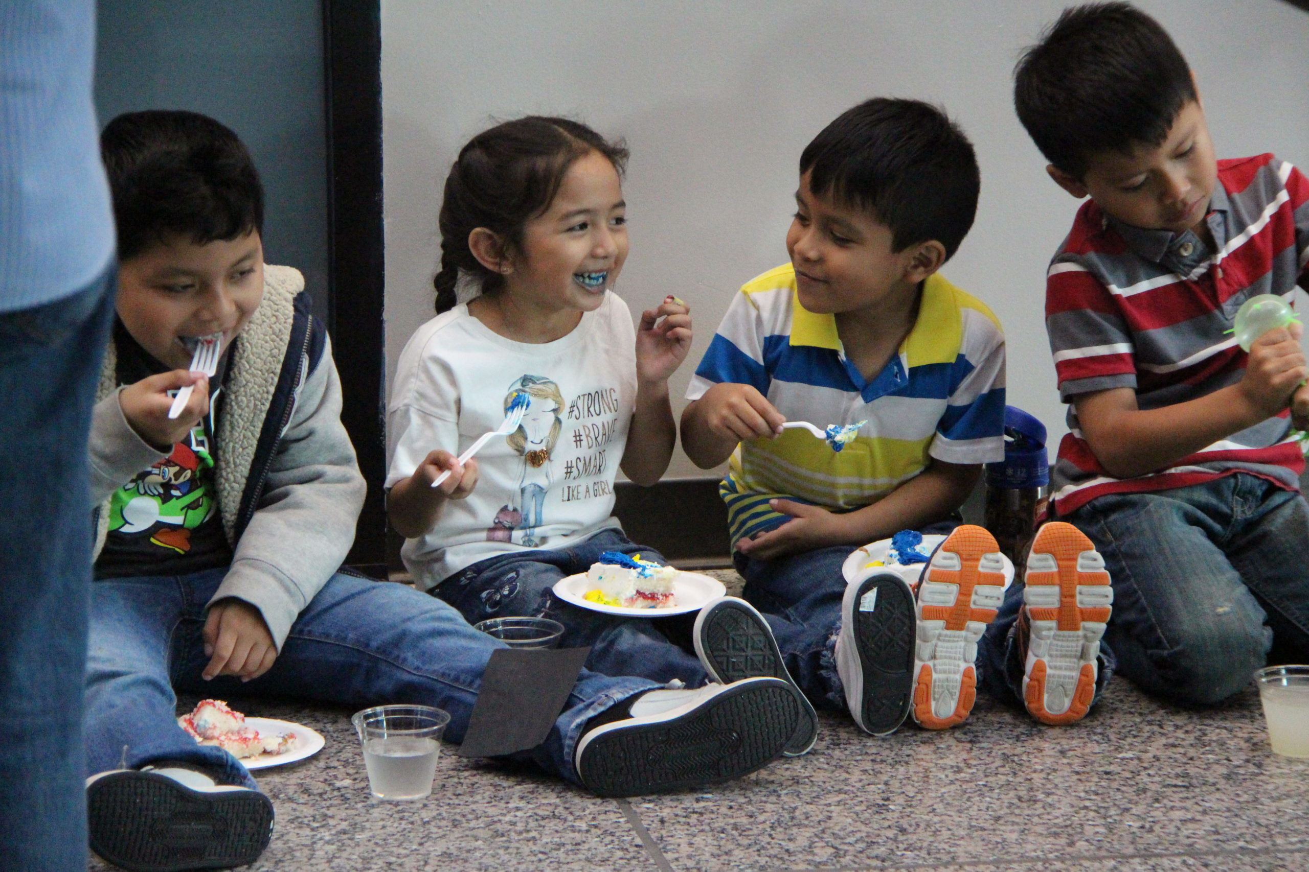 Young children eating cake