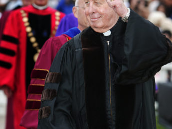 Albert Koppes, O. Carm. salutes the crowd before recieving an honorary degree and giving the keynite address.