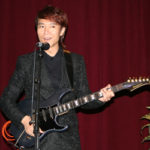 Se-Hwang Kim playing the electric guitar