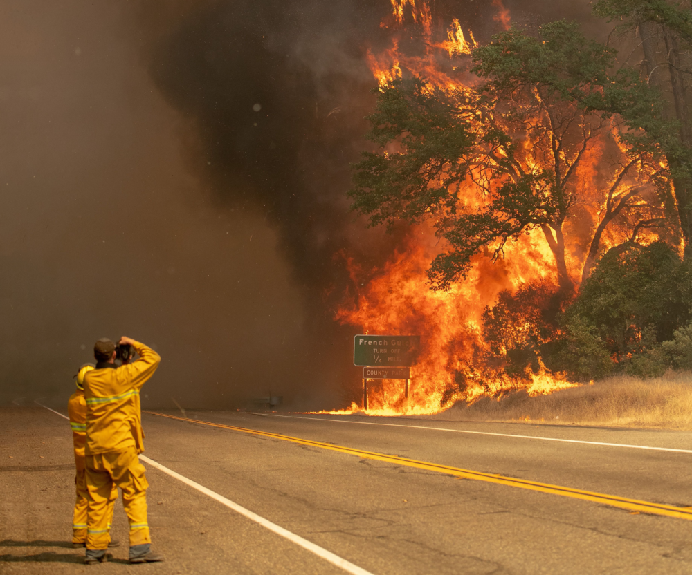 Firemen in front of wildfire