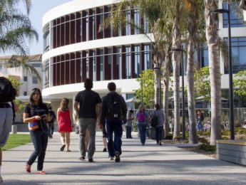 Students walking toward William H. Hannon Library on LMU campus