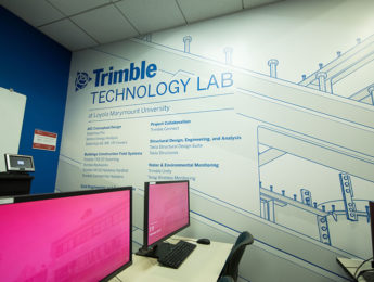 Trimble Technology Lab photo showing two computer monitors and Trimble Technology Signage