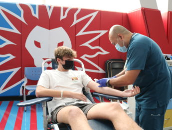 Male student donates blood in Burns Back Court during the fall blood drive.