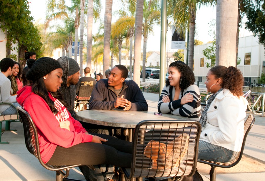 Image of students sitting around a table.