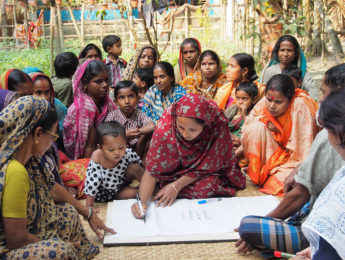 A group of women engaging in a mapping exercise in Bangladesh, related to the Business for Good Program at LMU