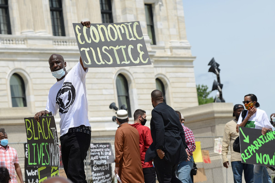 Protesters with signs for economic justice