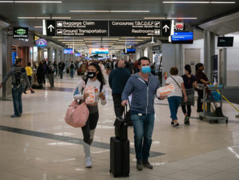 Flyers at Hartsfield-Jackson Atlanta International Airport wearing face masks