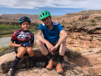 Gregory Ruzzin and his son Zachary resting during a bike trip