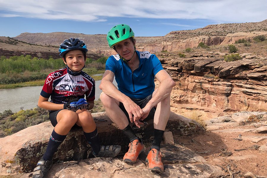 Gregory Ruzzin and his son Zachary resting during a bike trip