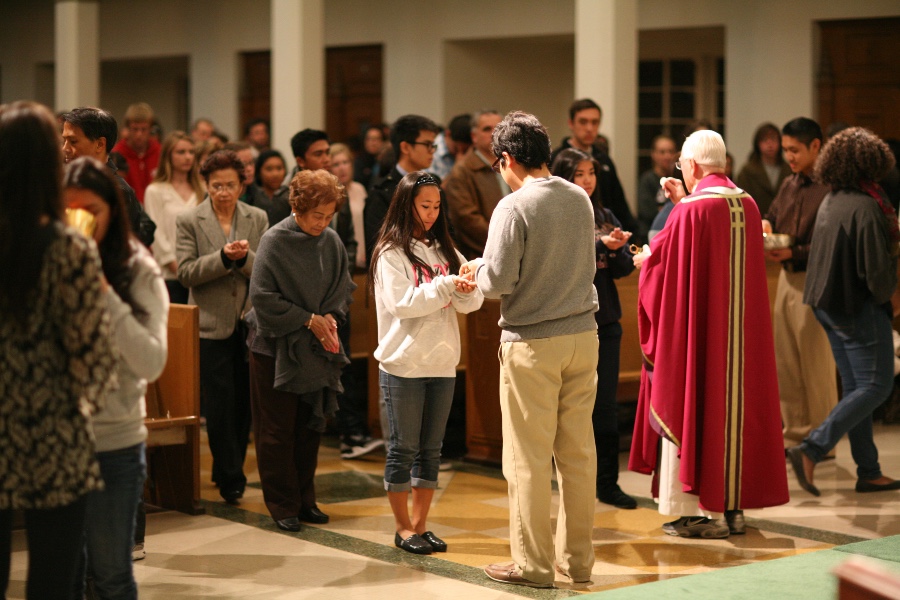 People at Mass receiving communion