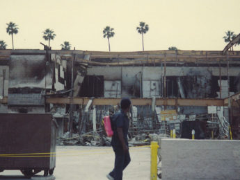 Man walks by damaged L.A. building