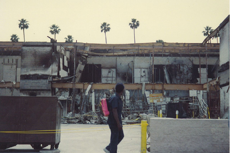 Man walks by damaged L.A. building