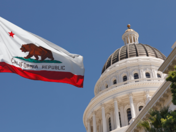 CA State Capitol with state flag flying adjacent