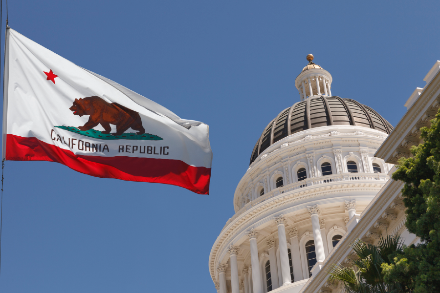 CA State Capitol with state flag flying adjacent