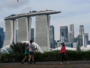 People walk along Marina Bay East Park in Singapore