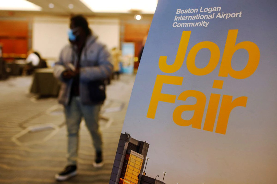Man passing by sign for job fair