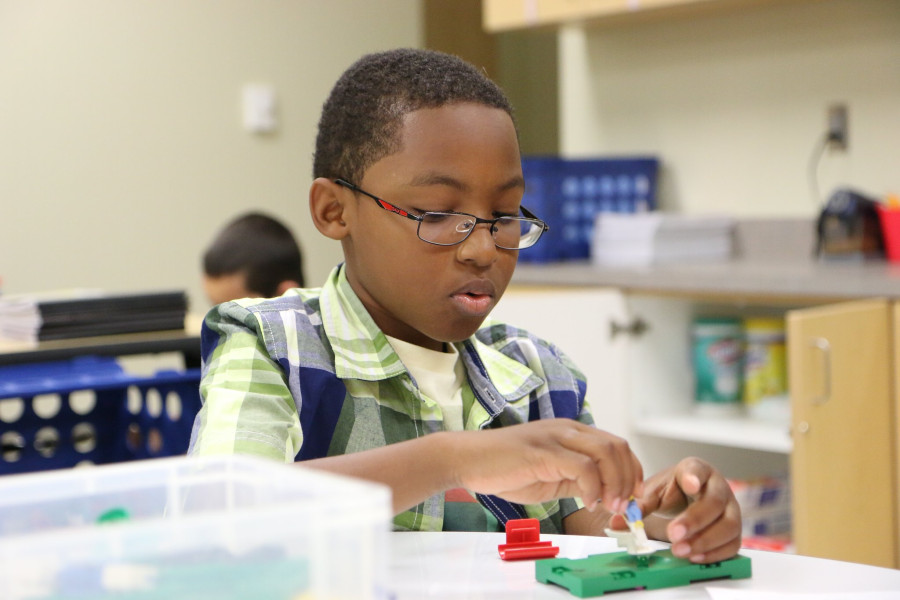 student in classroom with hands-on activity