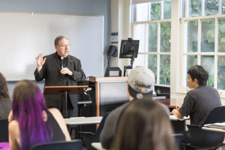 Father Deck teaching students at Loyola Marymount University