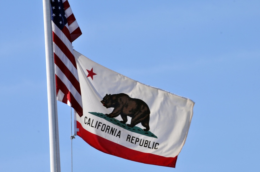 CA state flag next to the American flag
