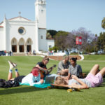 Students gather on LMU Campus with chapel in background