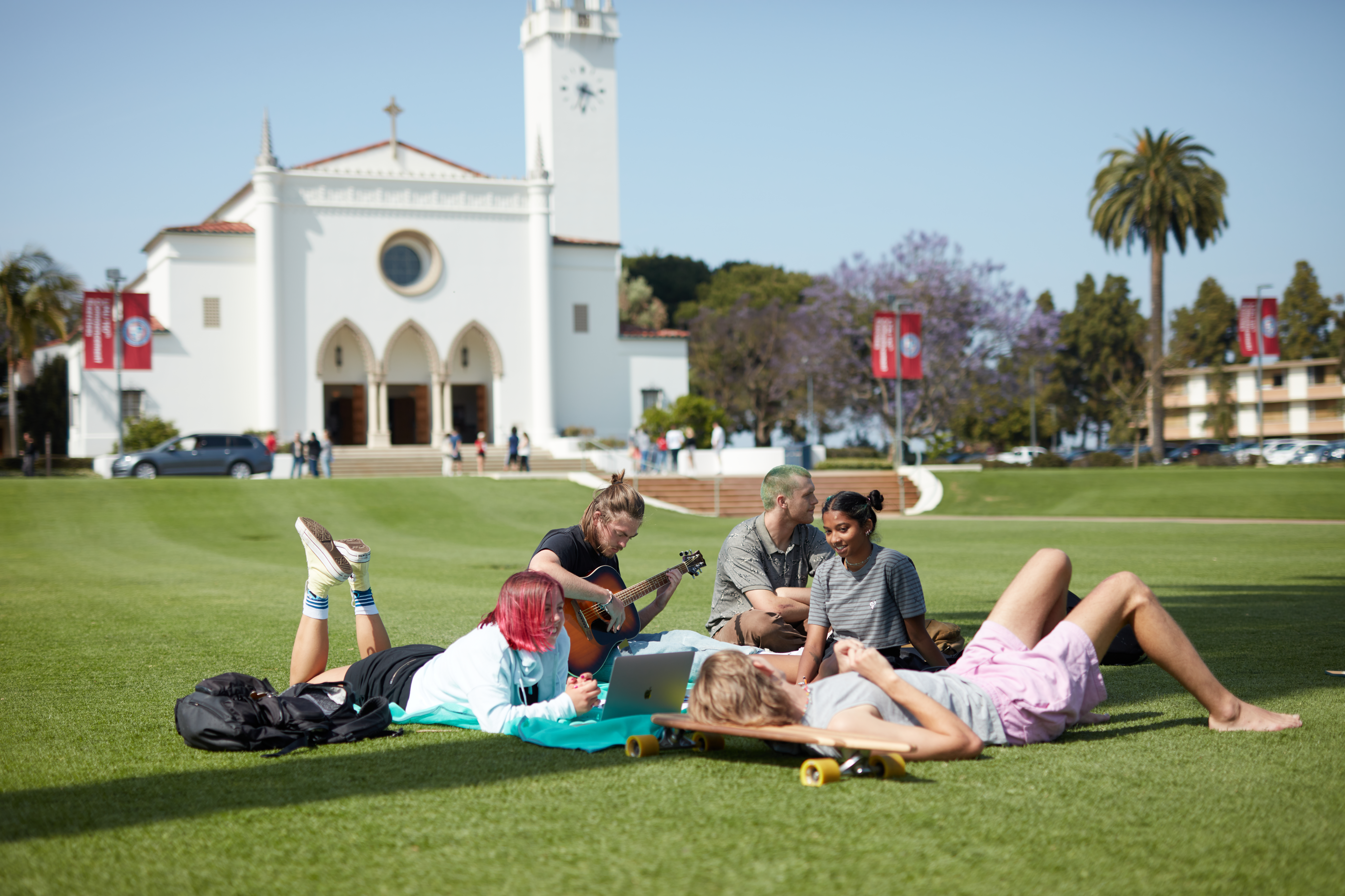 Students gather on LMU Campus with chapel in background