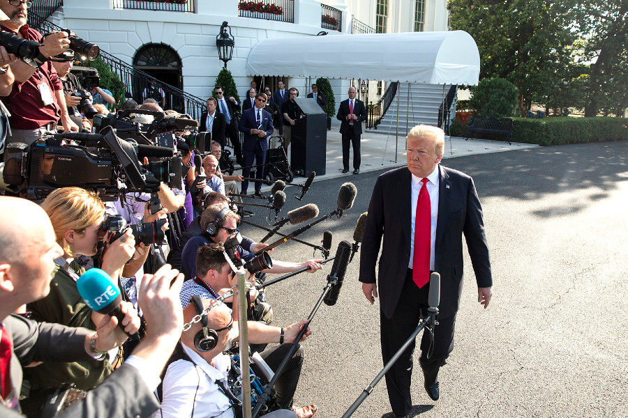 Former President Trump walking by reporters