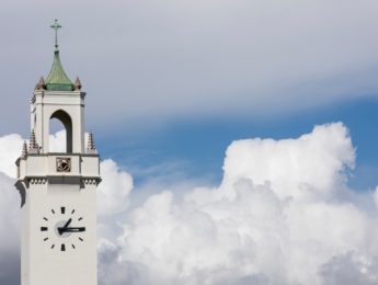 Image of the Sacred Heart Chapel tower with clouds in the background