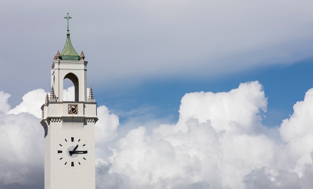 Image of the Sacred Heart Chapel tower with clouds in the background