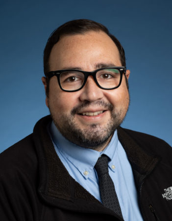 Headshot of Claudio Rodriguez, director of Chicano-x Latino-x Student Services
