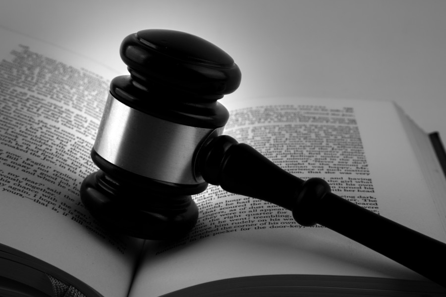 judge's gavel in legal book