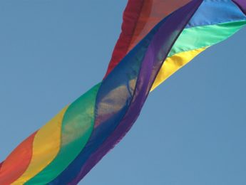 pride flag against blue sky