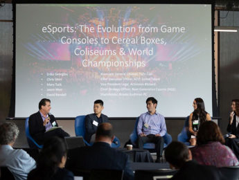 Panelists speaking in front of an audience in front of a screen saying eSports The Evolution from Game Consoles to Cereal Boxes Coliseums and World Championships Panel at LAIPLA TechTainment 5.0