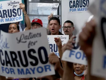 Voters in LA holding Caruso signs