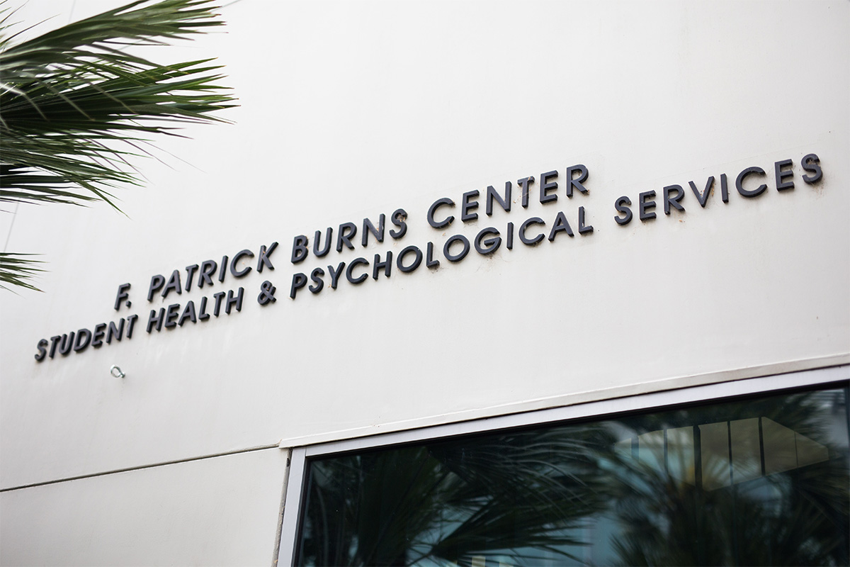 Exterior shot of the Burns Recreation Center building sign that includes Student Health and Psychological Services